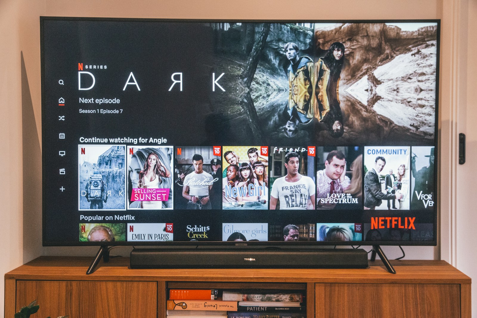 black flat screen tv turned on displaying man in black suit