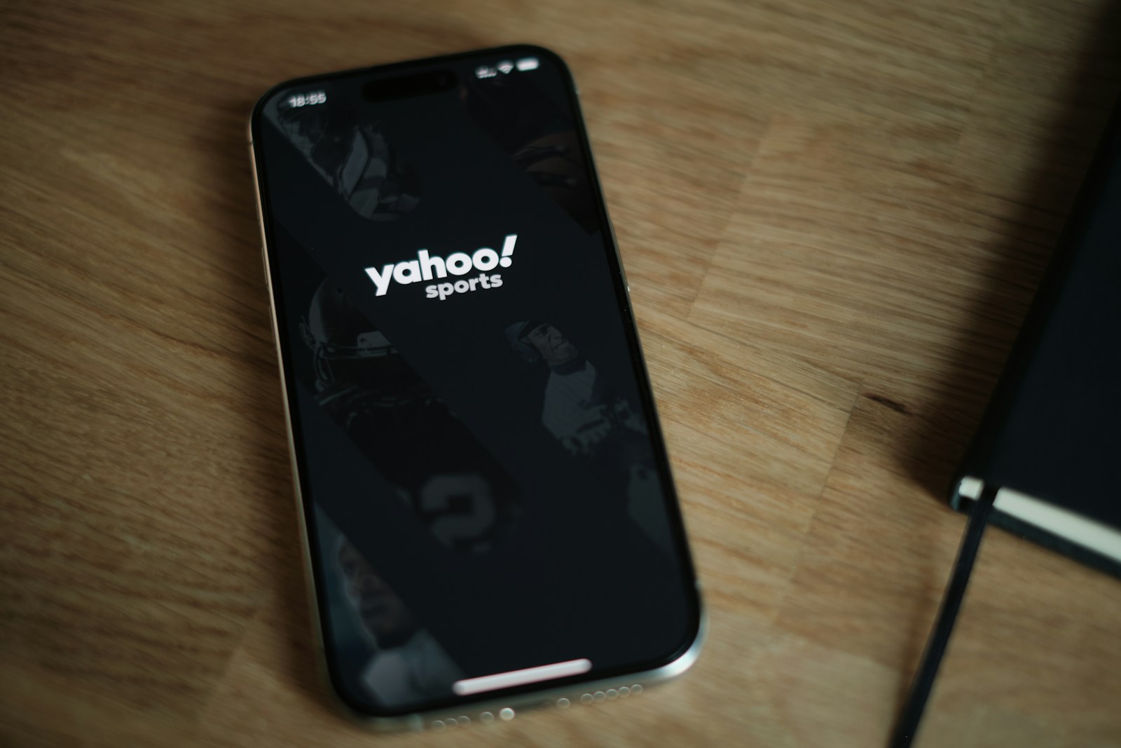 A cell phone sitting on top of a wooden table