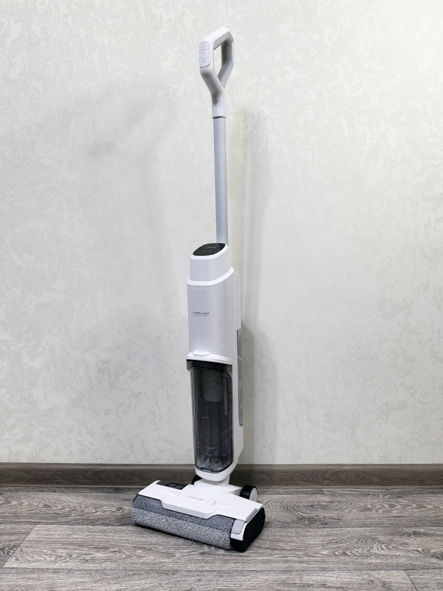 A floor sweeper sitting on top of a hard wood floor