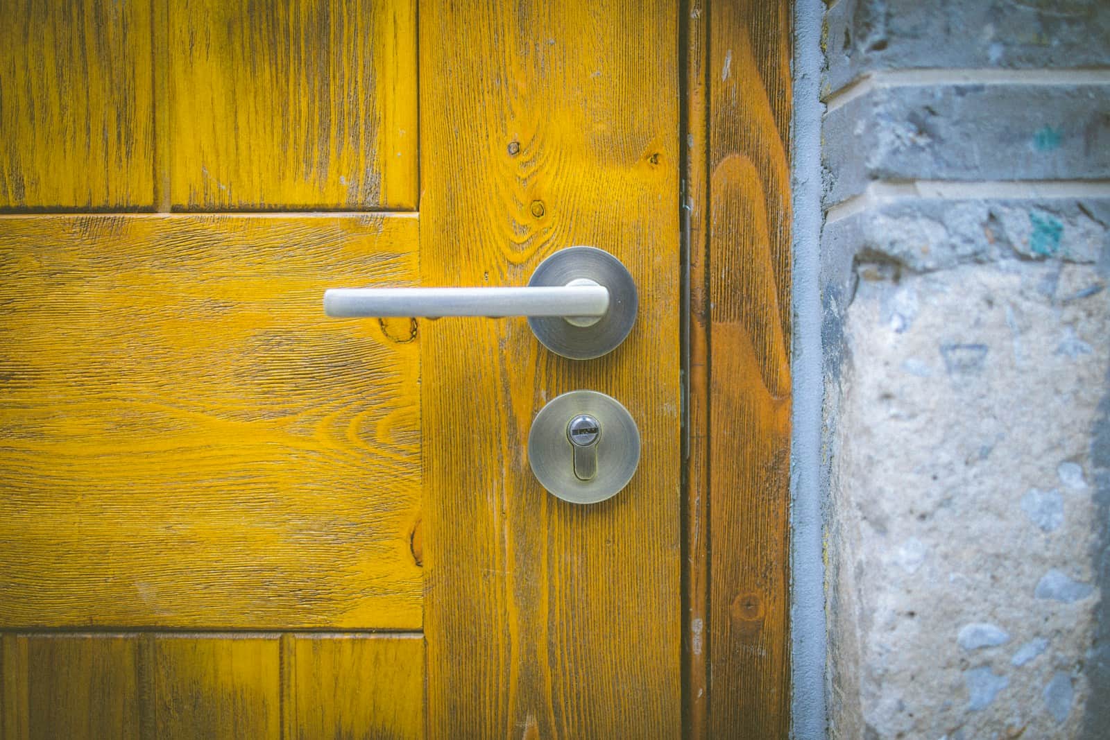 a yellow door with a white handle on it