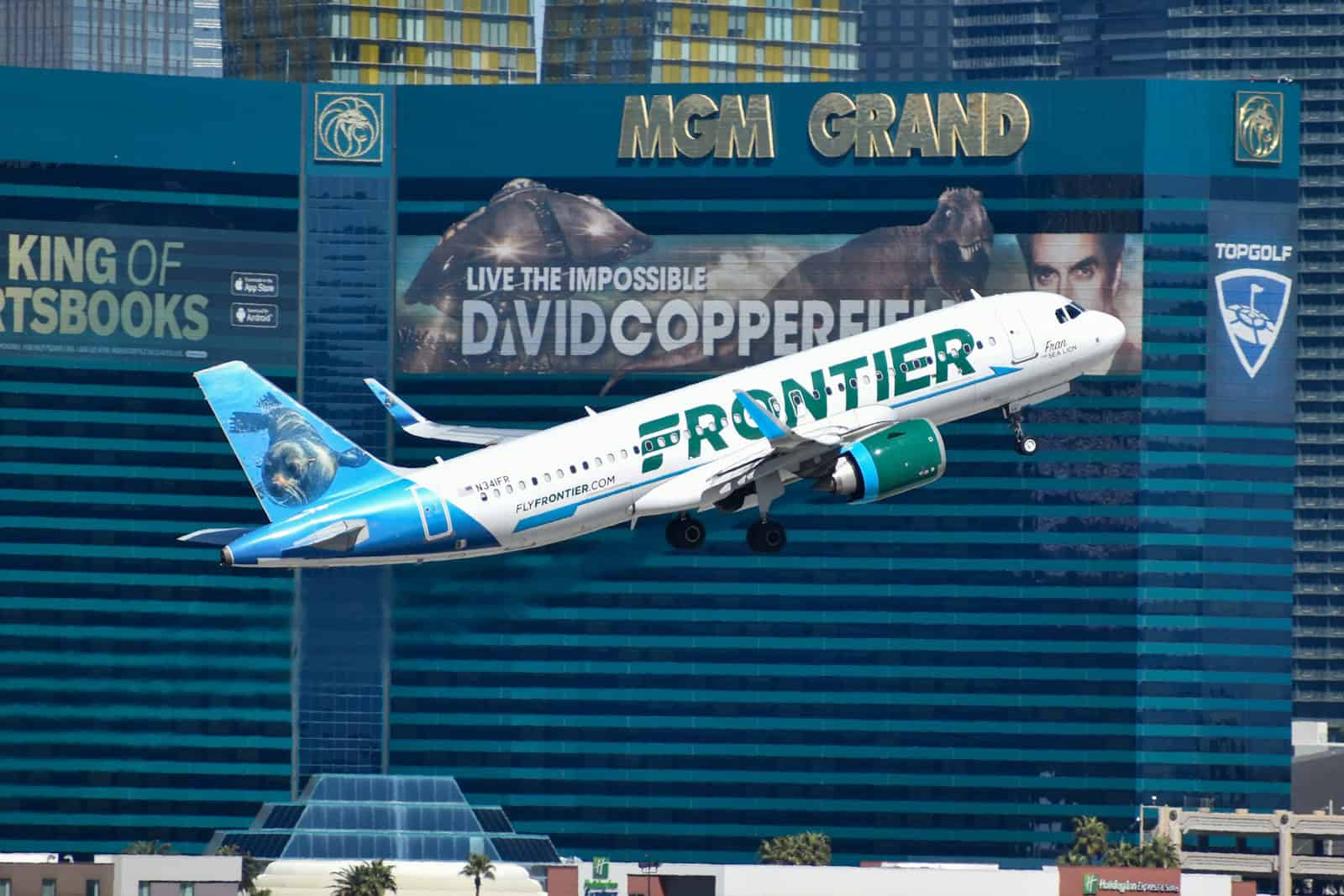 A large passenger jet flying over the las vegas strip