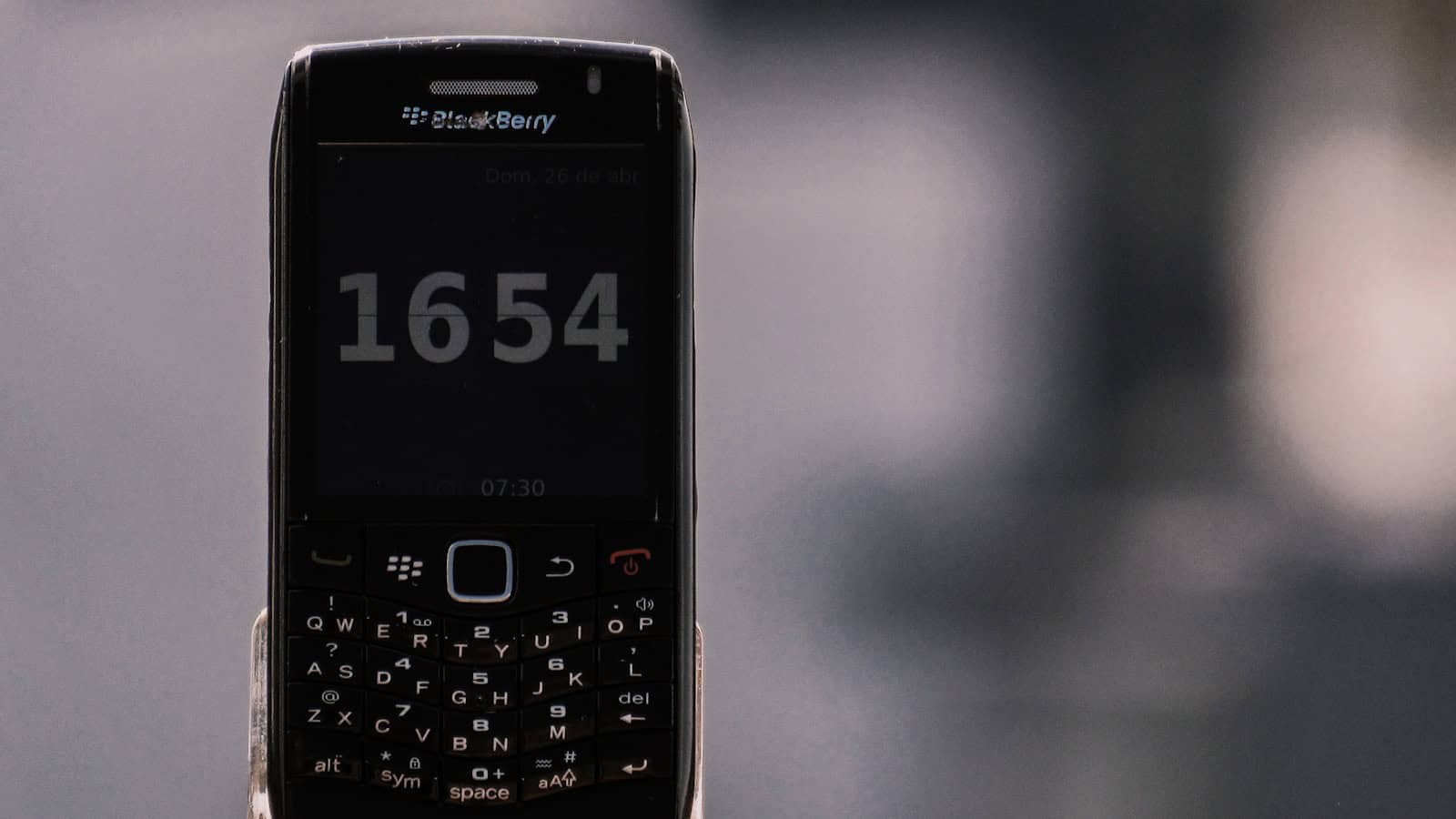 black nokia qwerty phone at 12 00