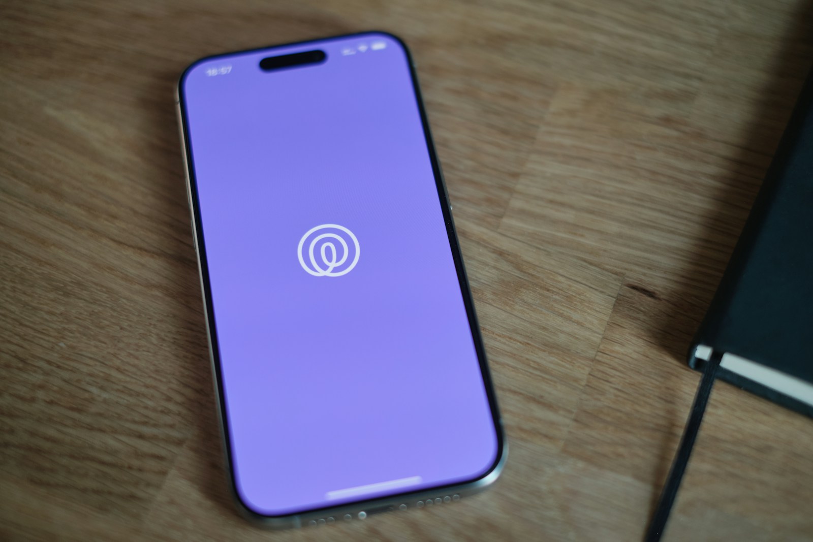 A cell phone sitting on top of a wooden table