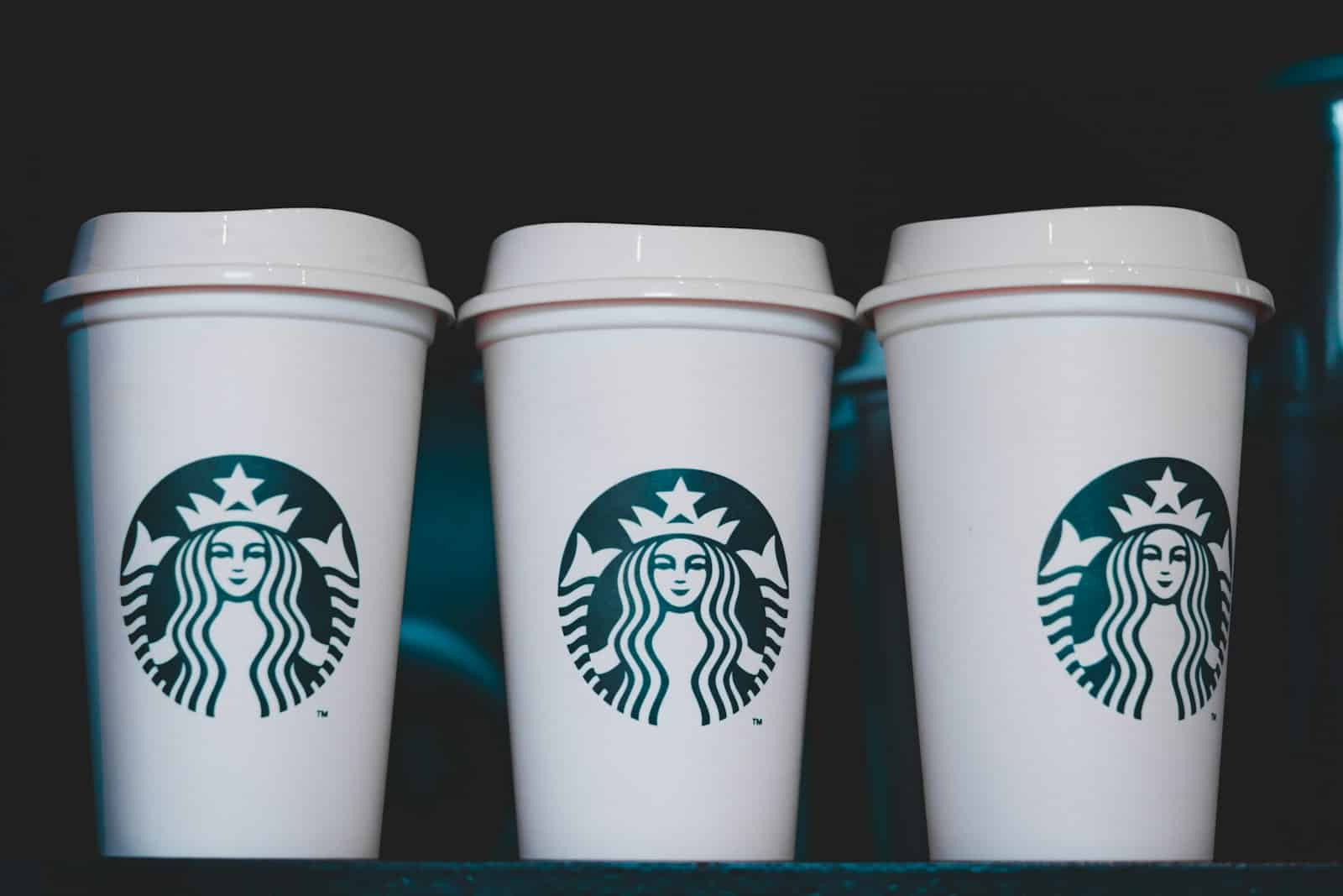 two white starbucks disposable cups