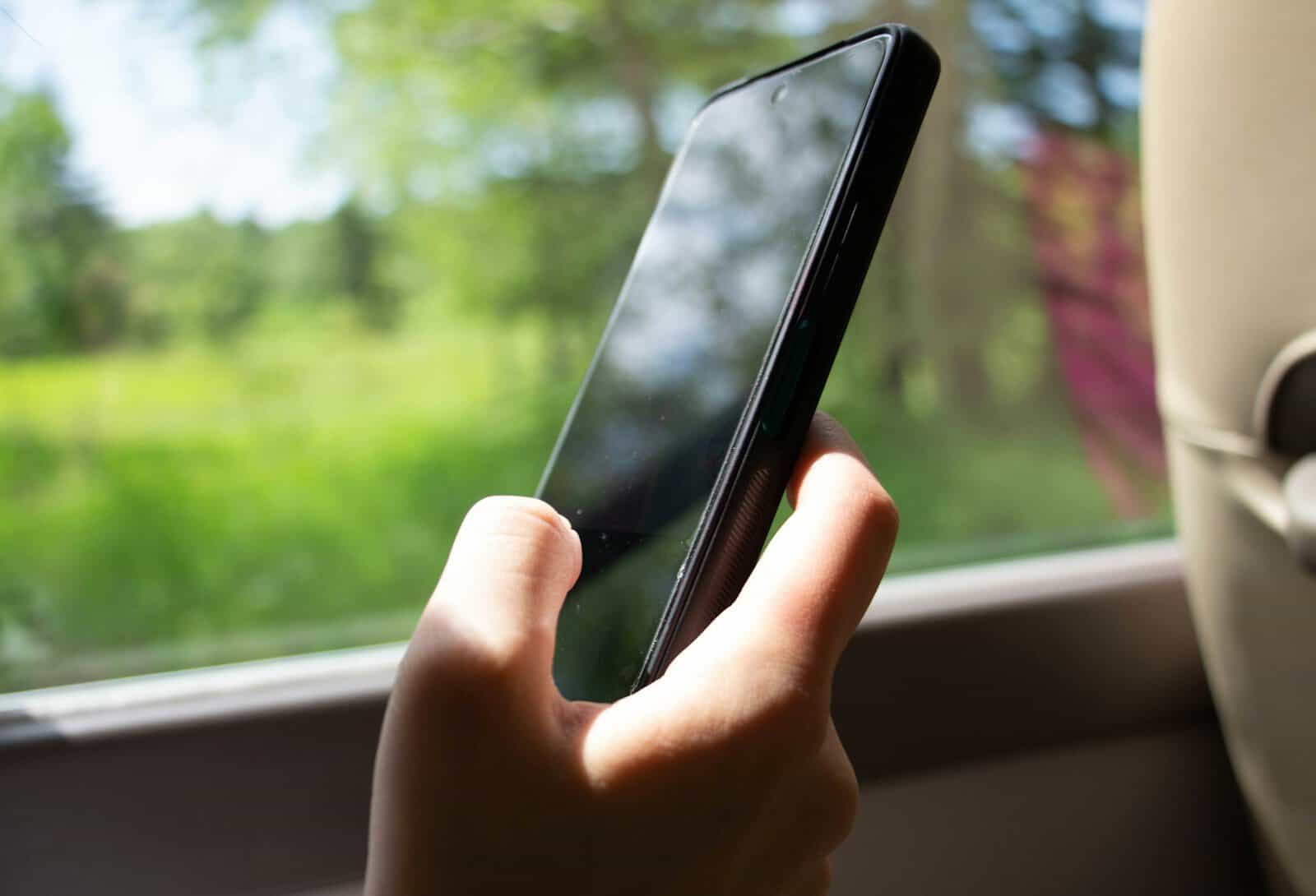 A person holding a cell phone in their hand