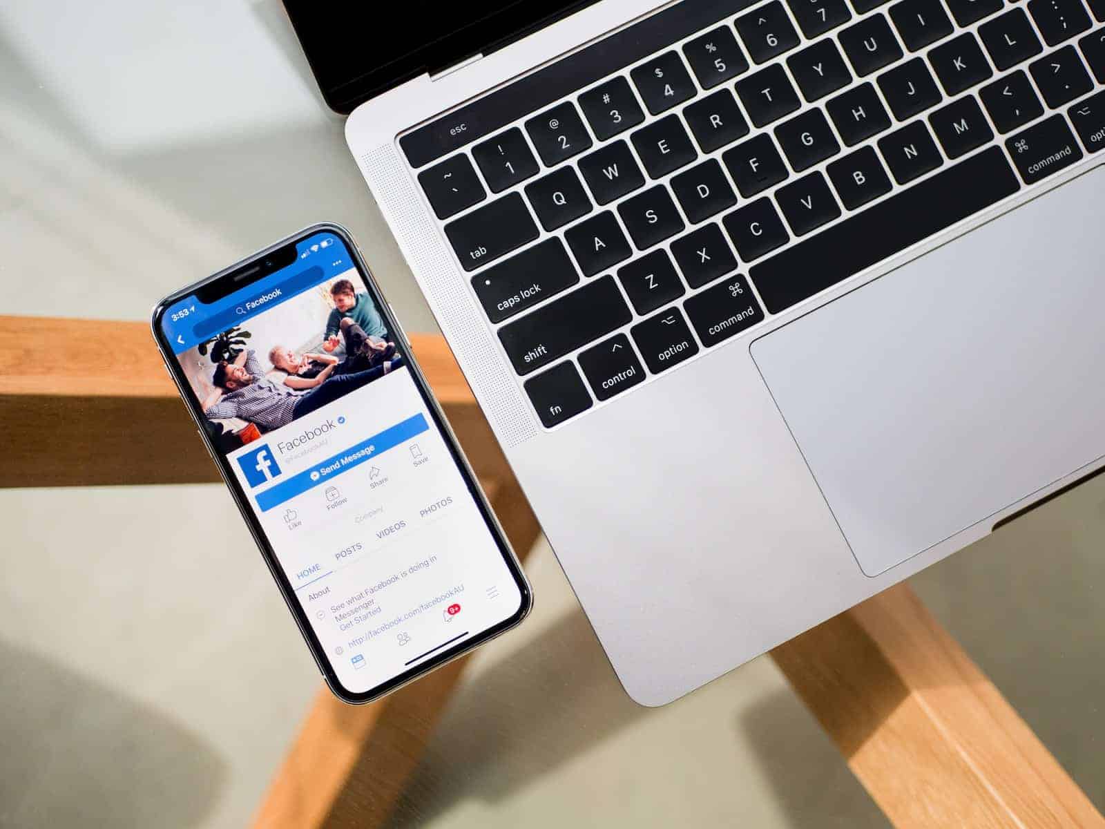 Facebook iPhone X beside MacBook on Facebook