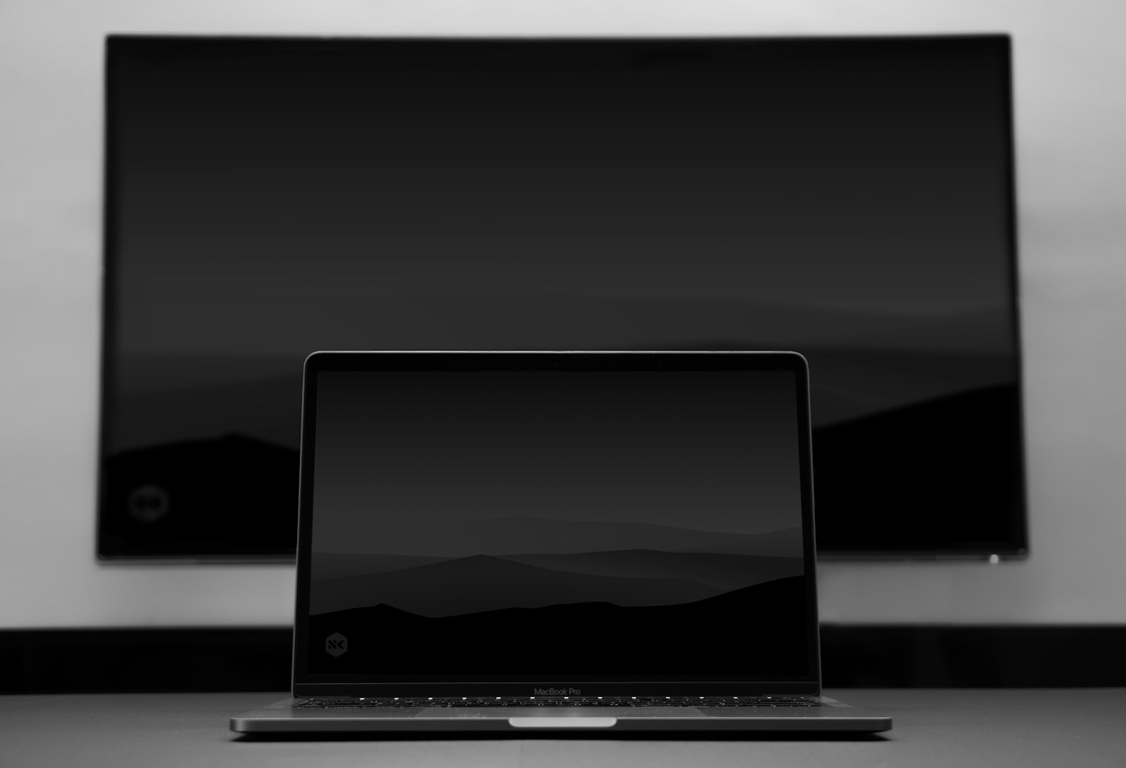 a laptop computer sitting on top of a desk