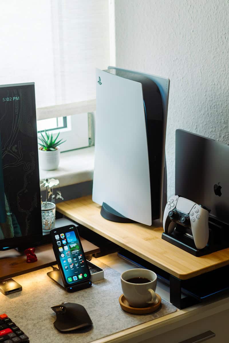 a desk with a cell phone, computer monitor, keyboard and mouse